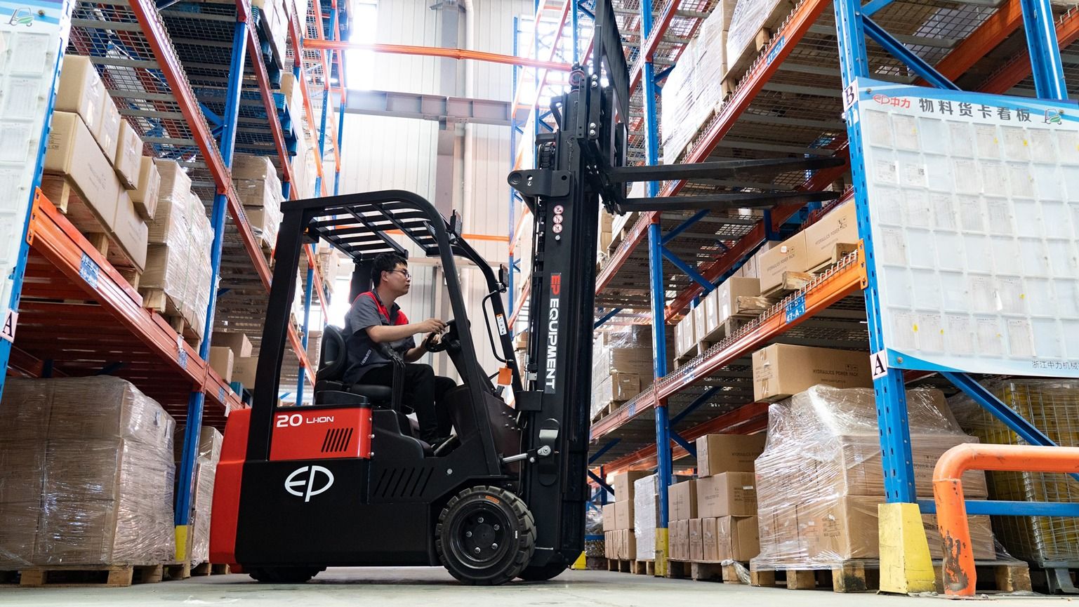Electric forklift in warehouse racking