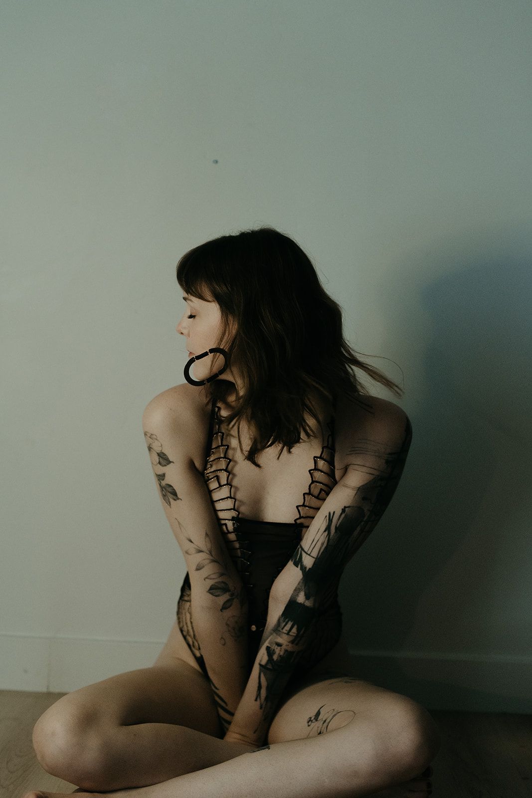tattooed rebel girl posing against a wall tattooed rebel girl posing against a wall