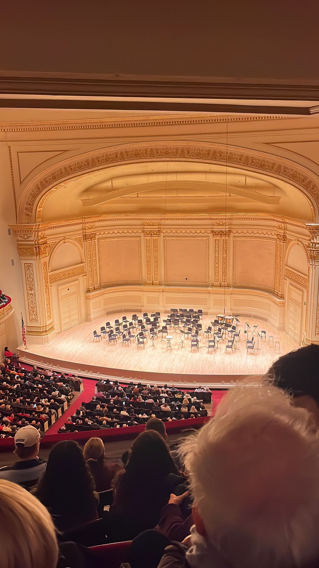 Carnegie Hall stage with orchestra chairs and music stands