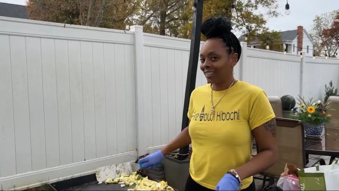 Rikki preparing food at a Fire Bowl hibachi event