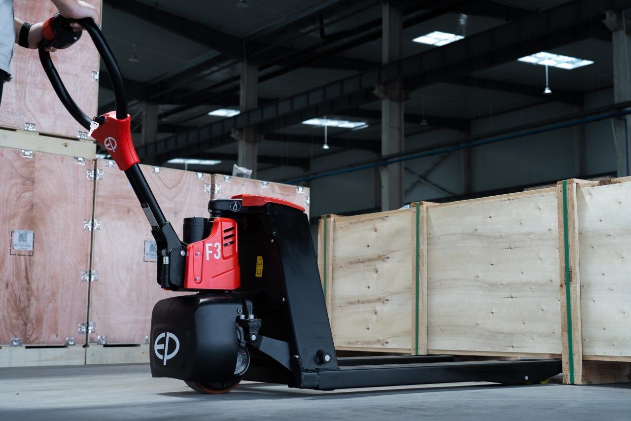 Powered pallet truck handling warehouse loads