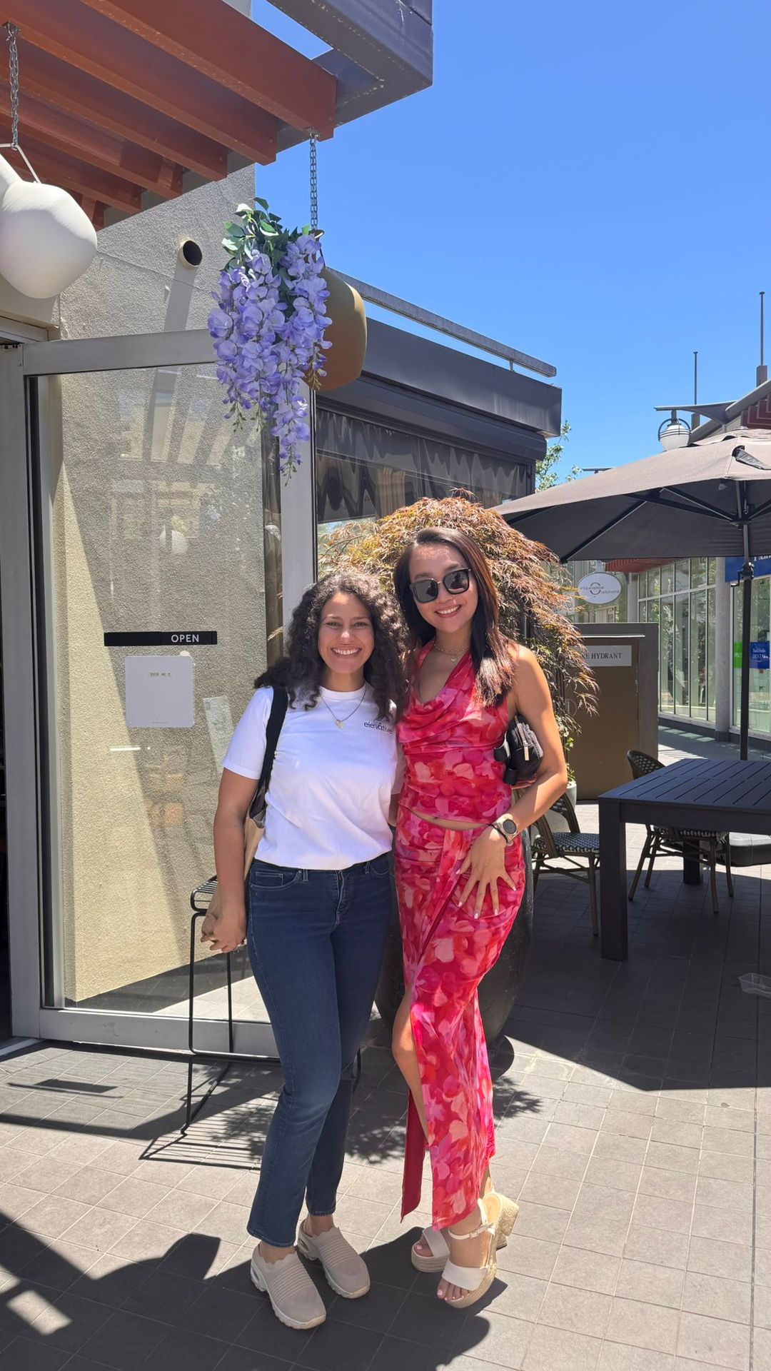 Mariana and her mentee standing and smiling Mariana and her mentee standing and smiling