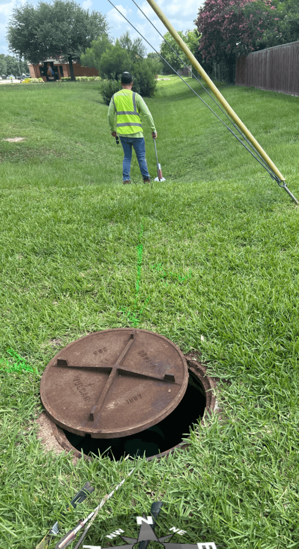 SiteTwin technician inspecting and documenting a manhole during a utility investigation