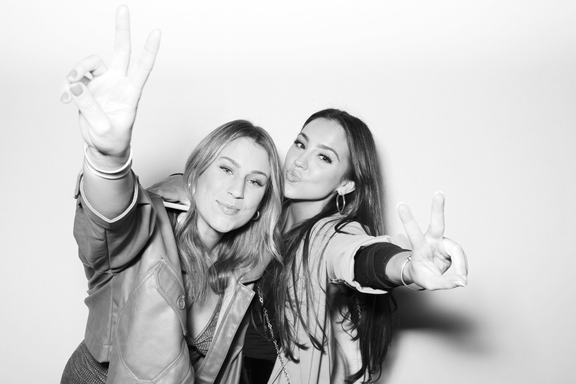 Guests posing in a modern open-air photo booth.