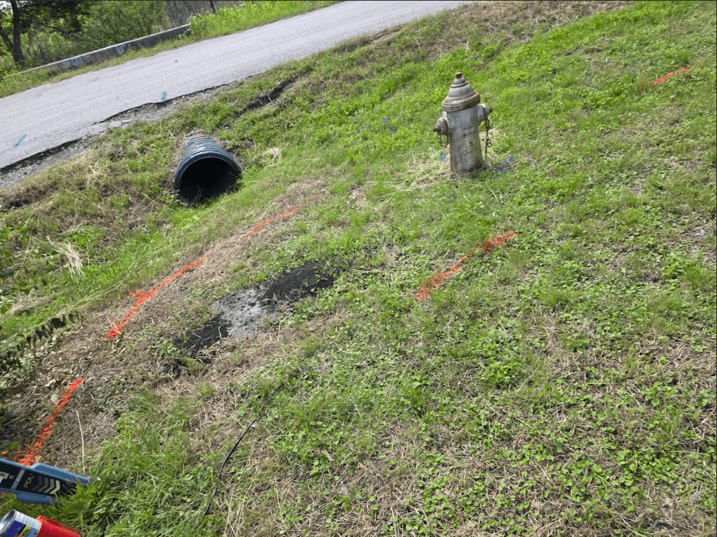 Utility locating markings near a fire hydrant in San Antonio, TX showing water and communication lines