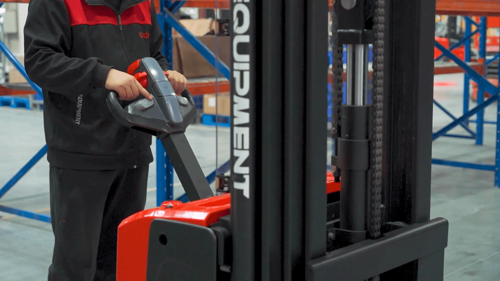 Electric stacker moving pallets in a warehouse