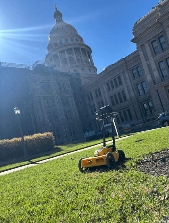 Ground penetrating radar (GPR) utility locating equipment positioned onsite at the Texas State Capitol in Austin, Texas for subsurface utility mapping and underground infrastructure scanning Ground penetrating radar (GPR) utility locating equipment positioned onsite at the Texas State Capitol in Austin, Texas for subsurface utility mapping and underground infrastructure scanning