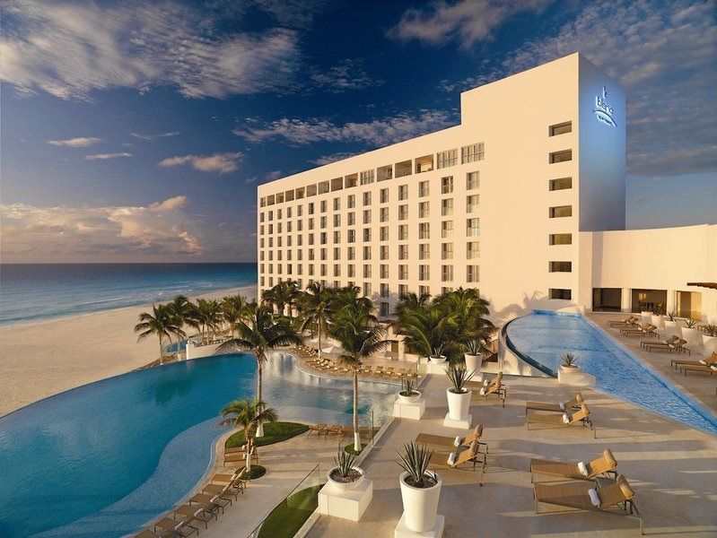 Le Blanc Spa Resort in Cancun with oceanfront infinity pools at sunset