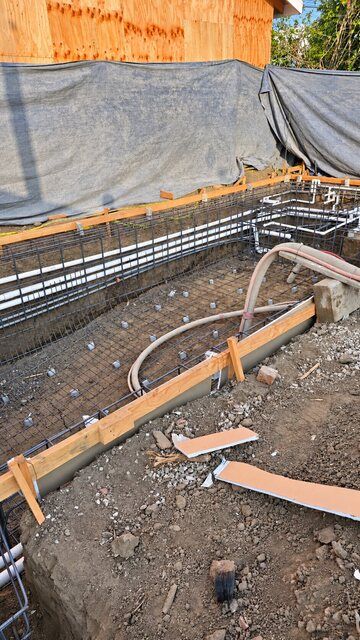 Pool reinforcing steel and plumbing before concrete placement