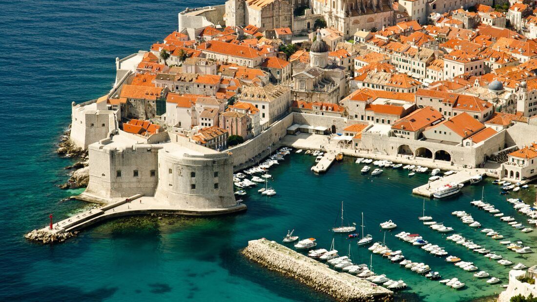 Dubrovnik Old Town and harbor beside the Adriatic Sea.