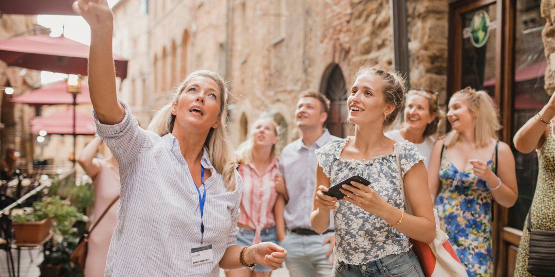 A small group of travelers follows a local guide through a charming historic European street, enjoying personalized sightseeing, cultural insights, and an intimate guided vacation experience. A small group of travelers follows a local guide through a charming historic European street, enjoying personalized sightseeing, cultural insights, and an intimate guided vacation experience.