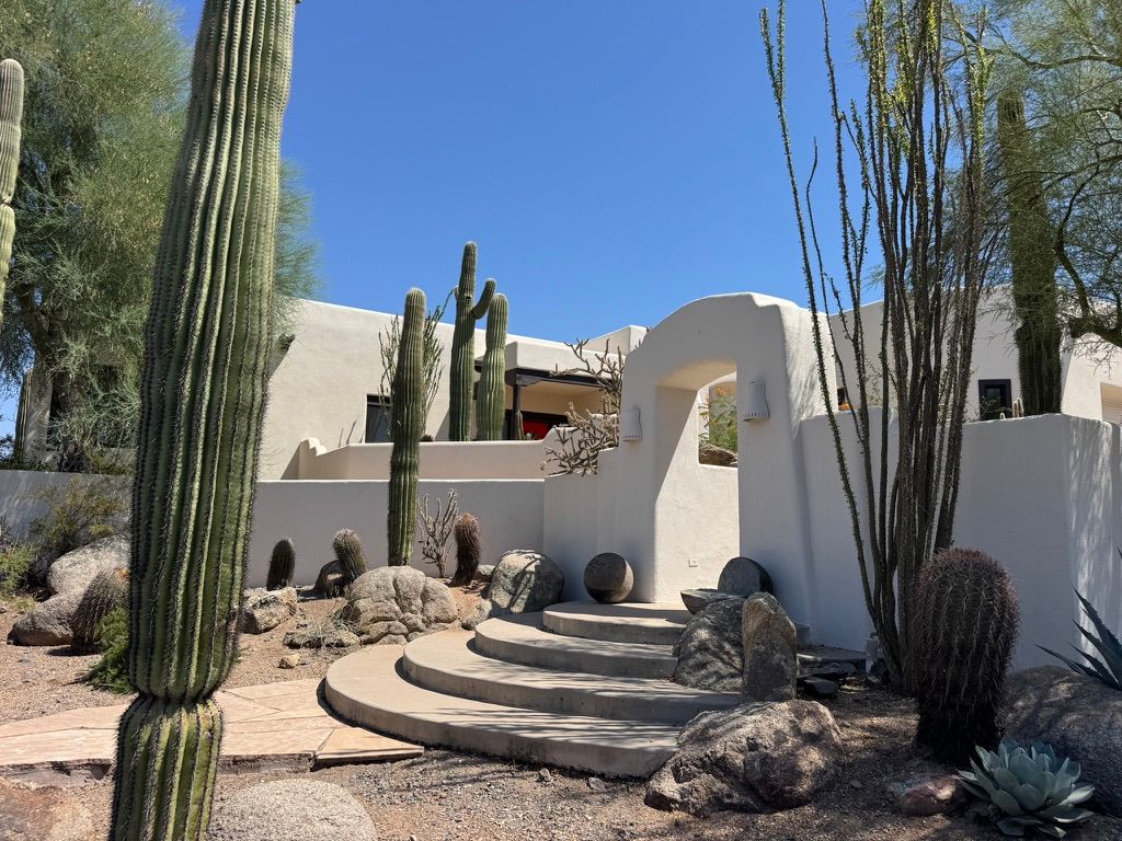  Ivory Adobe Cave Creek Arizona estate property entry steps and arch flanked by desert landscaping protected by TSPE GOLD pest control 