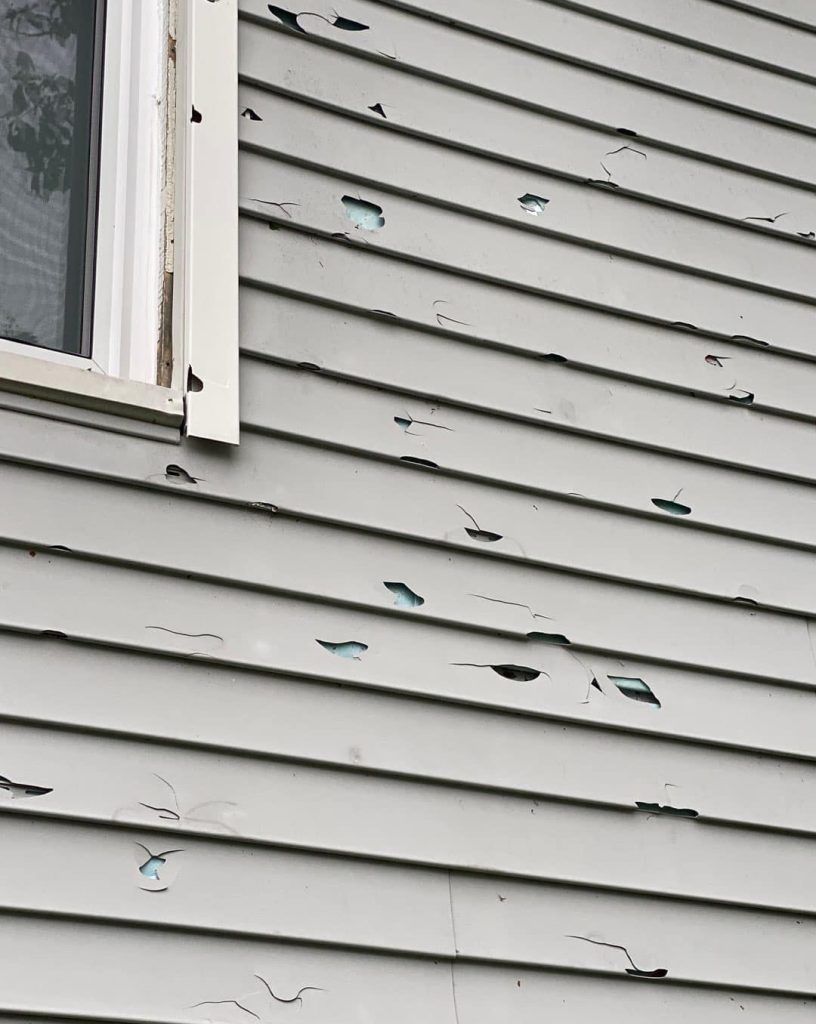 a wooden bench with broken glass on it