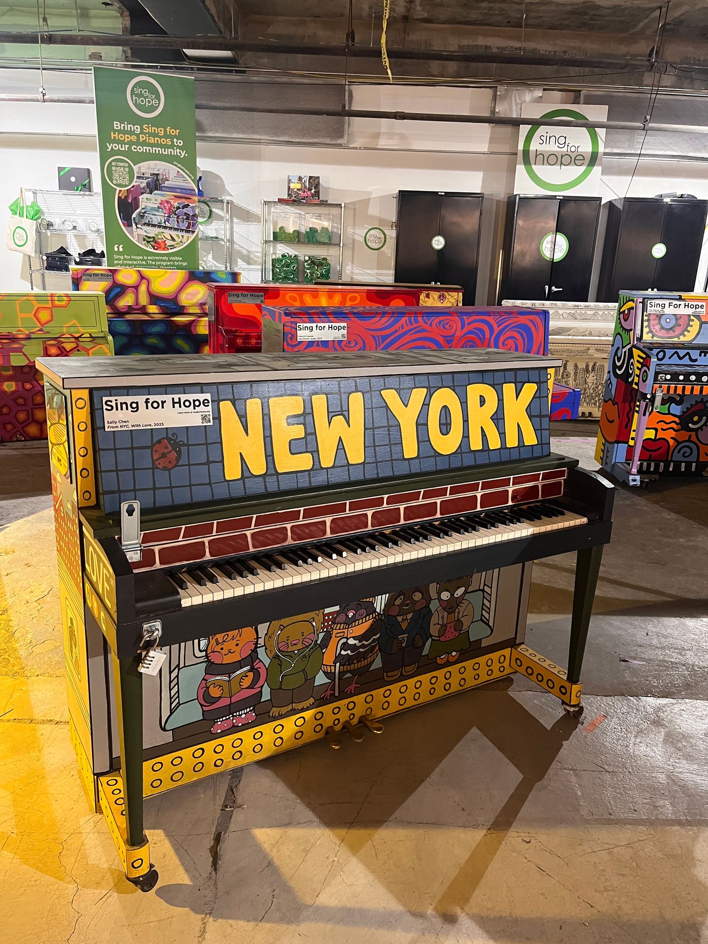 Piano that has NEW YORK written across the front with subway tile and brick painted on it Piano that has NEW YORK written across the front with subway tile and brick painted on it