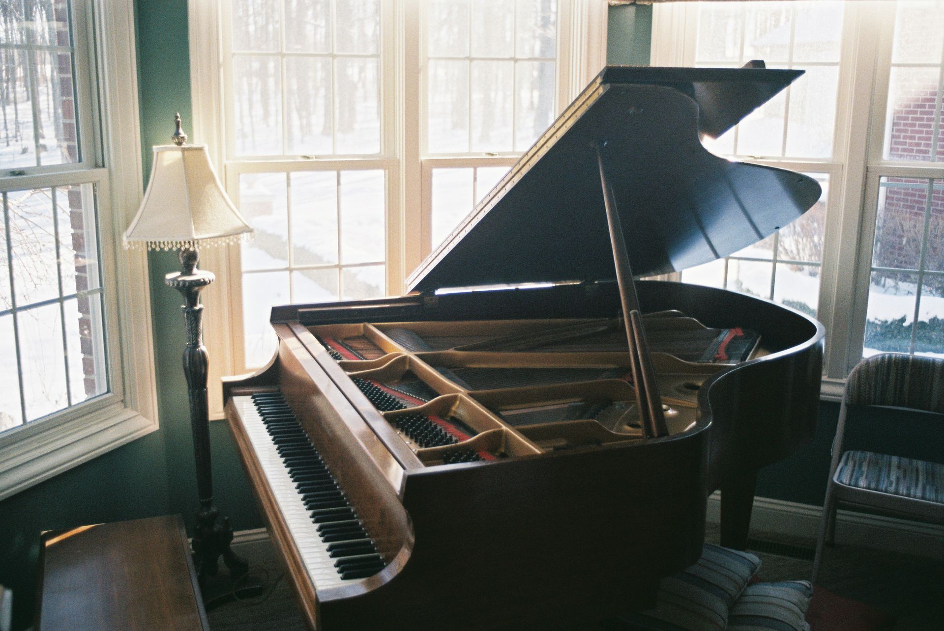 Grand piano in sunlit window