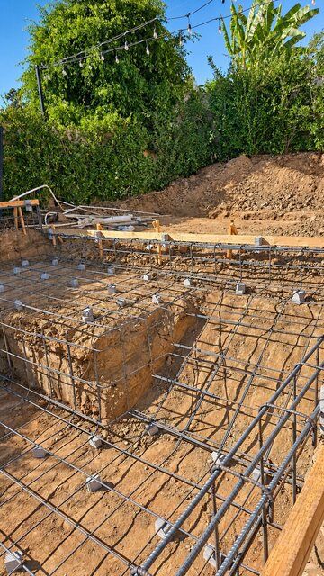 Reinforcing steel following the excavated pool shelf and walls