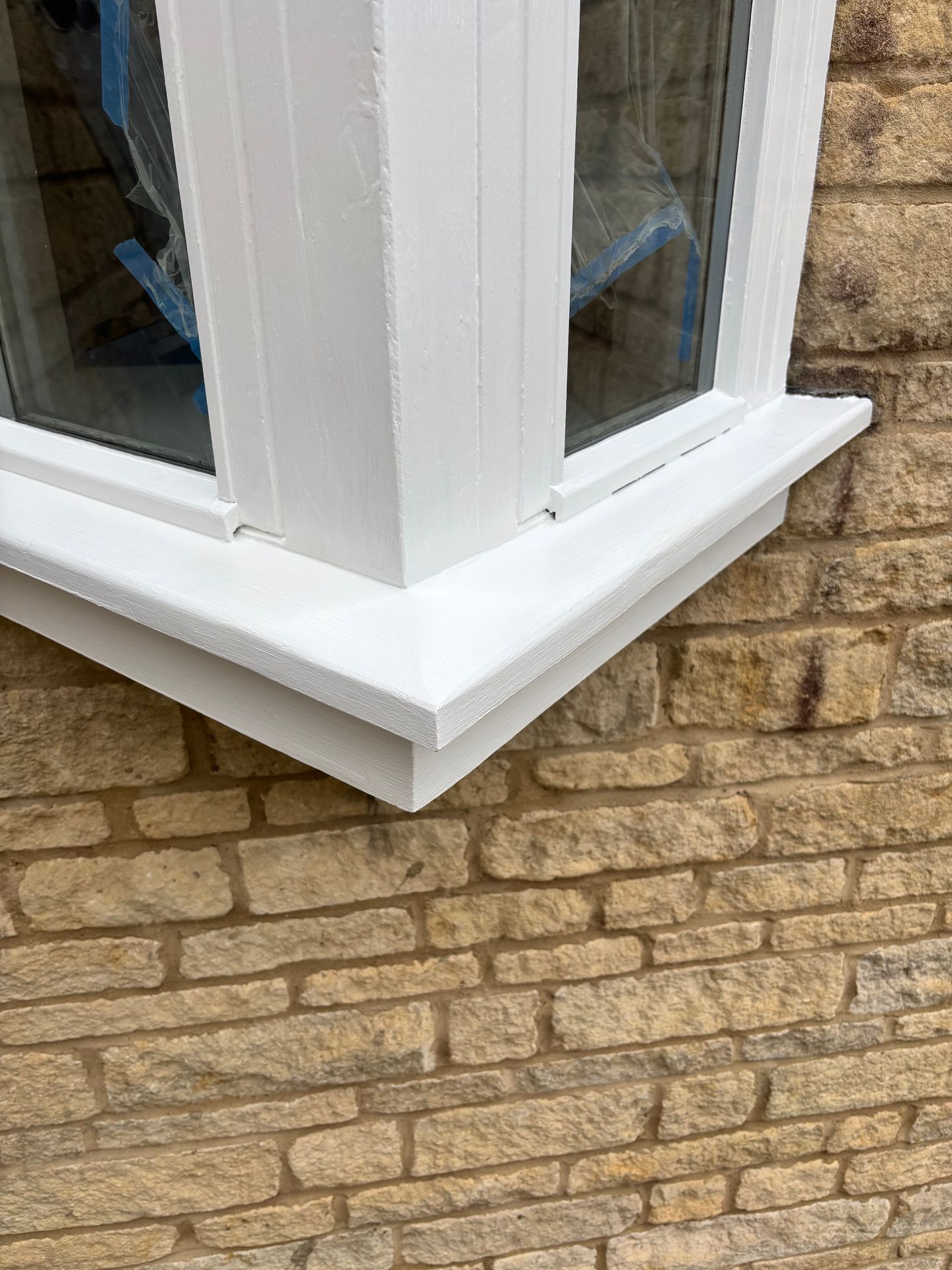 Exterior timber window corner fully repaired and painted in bright white satin finish.