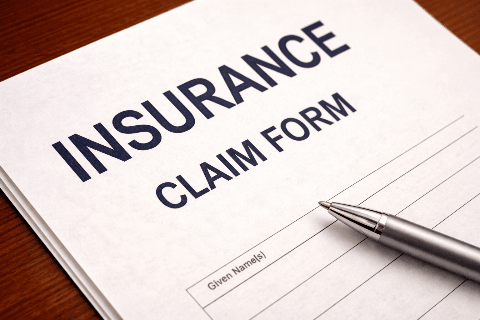 insurance form, calculator and pen on the table