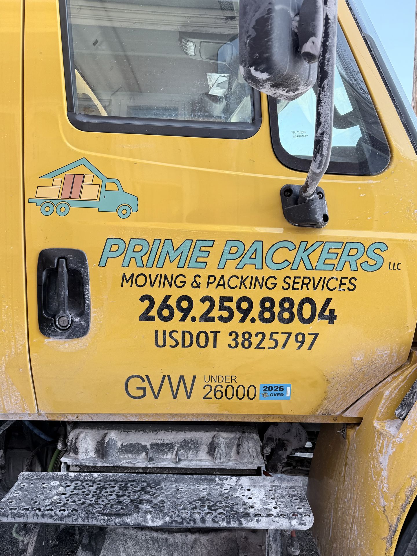 Prime Packers LLC branded moving truck door showing company logo, phone number 269-259-8804, and USDOT 3825797