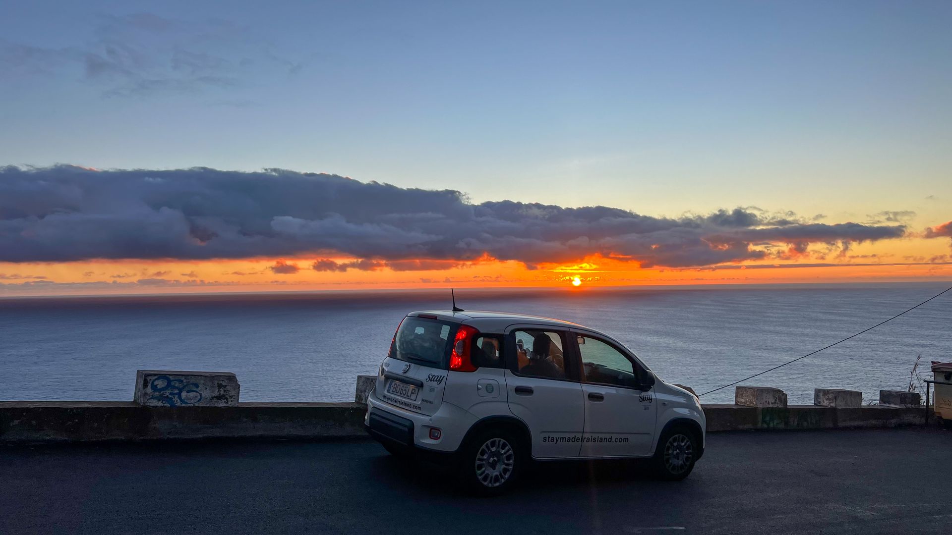 Car rental in Madeira with no deposit β car driving on scenic mountain road with ocean view Car rental in Madeira with no deposit β car driving on scenic mountain road with ocean view
