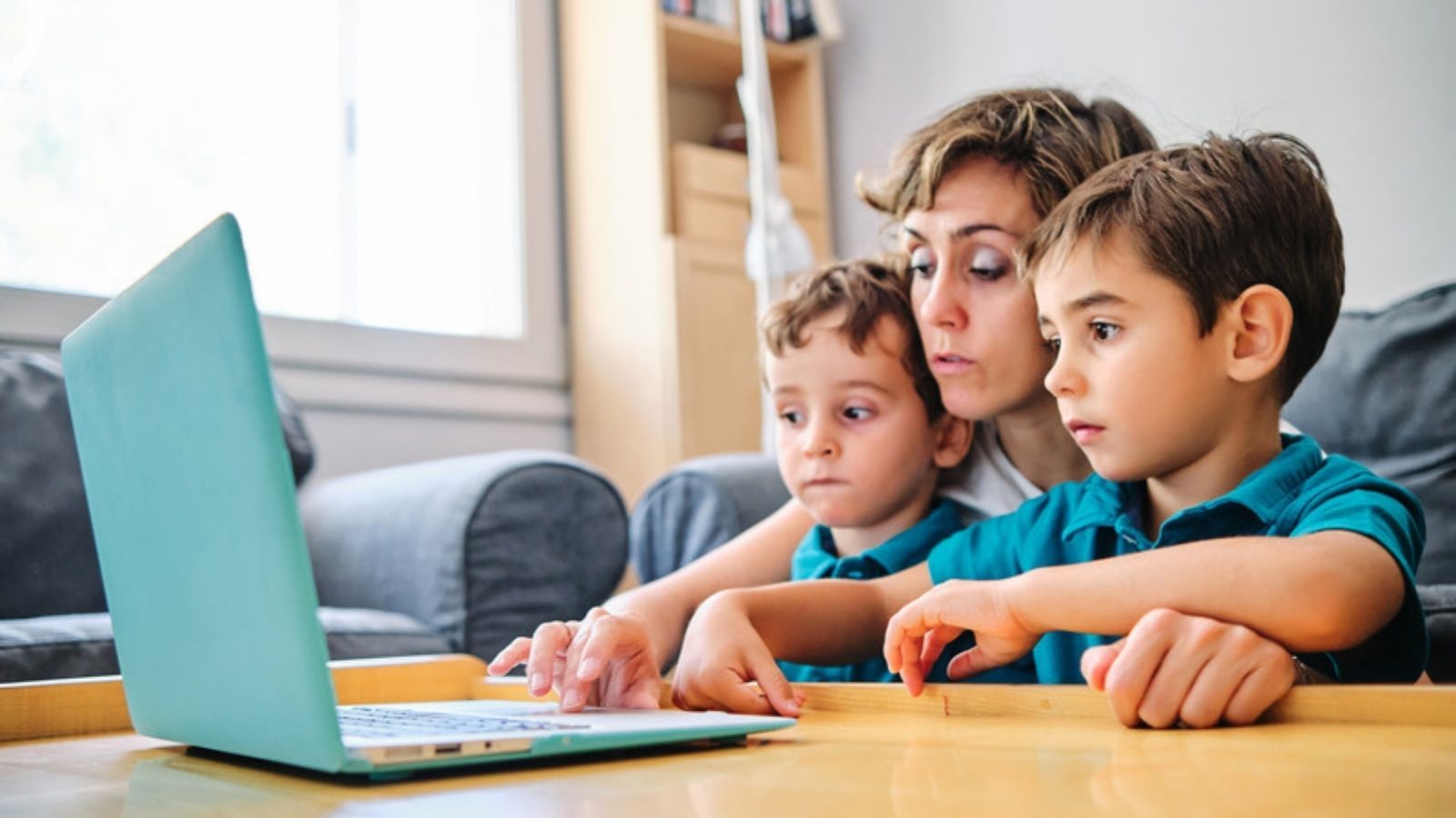 Mum showing her children how to stay safe online on a laptop, Online Safety Across Three Generations of My Family
