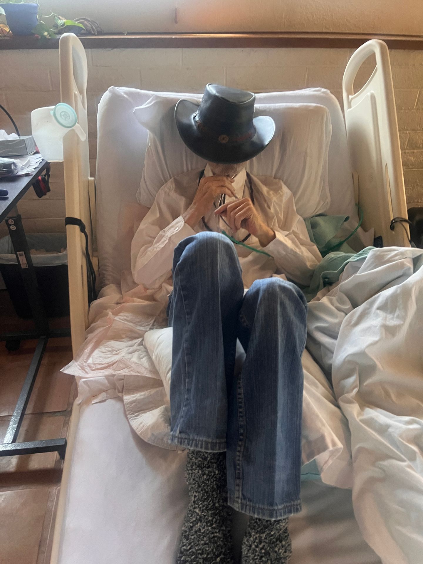 Dying Man in his bed dressed as a cowboy