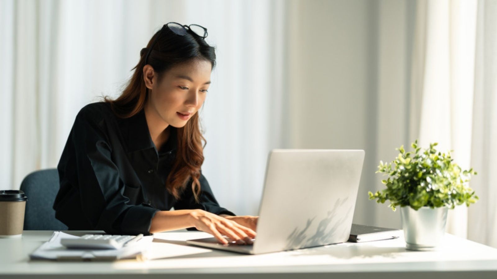 Woman reading online safety advice on her laptop, The Online Safety Tips I Think Matter, and Ones I Don't