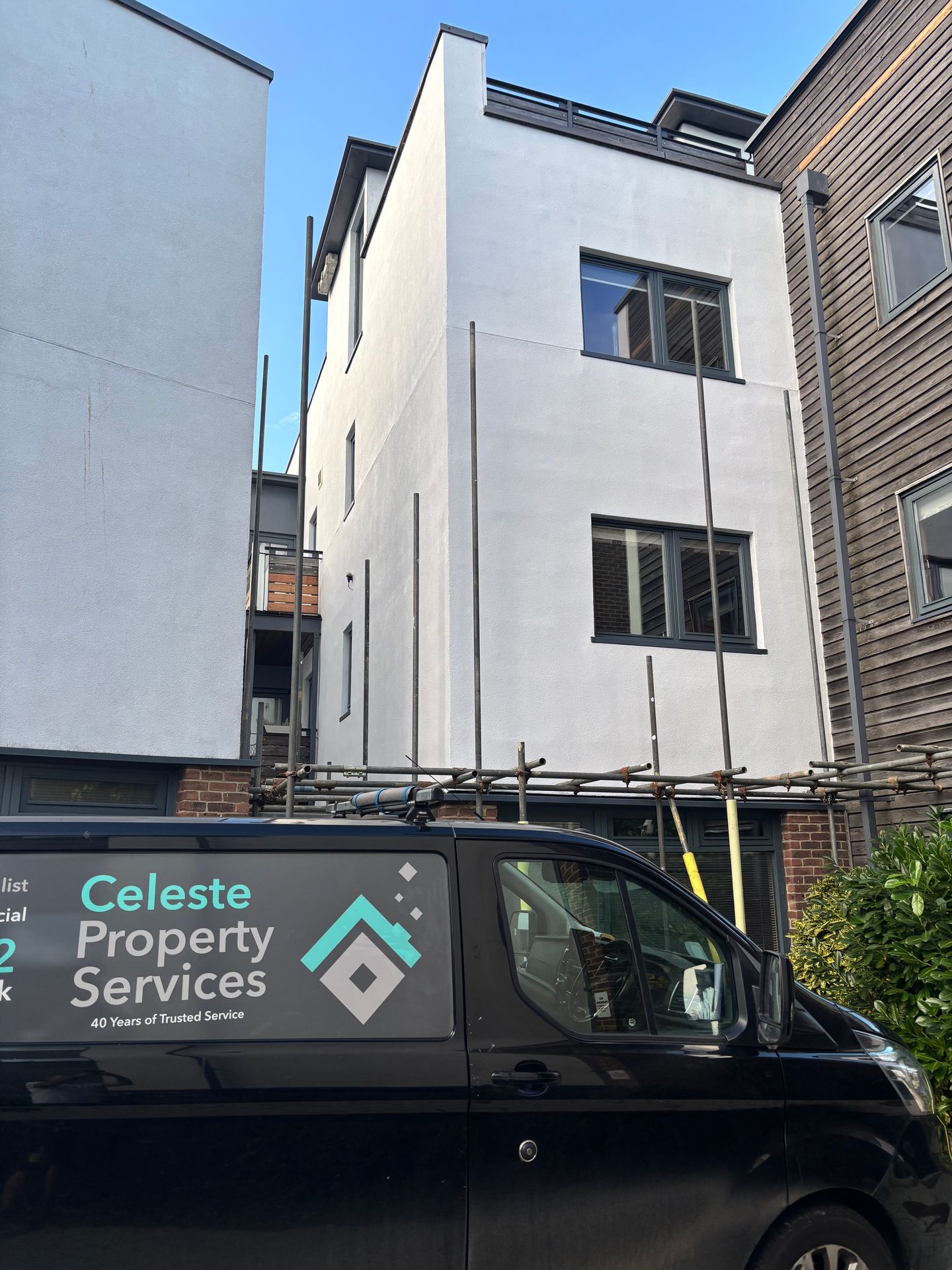 Freshly painted exterior render in Dulux Weathershield Pure Brilliant White with windows finished in RAL 7011 grey.