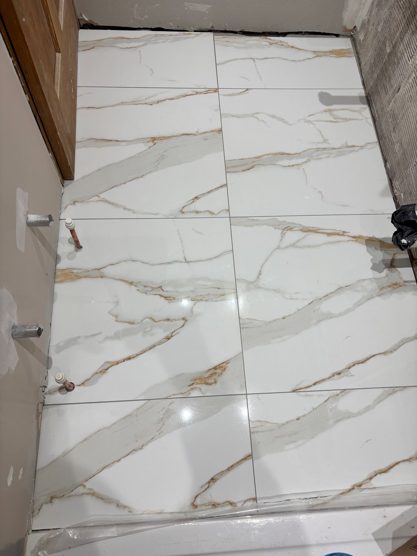 Completed porcelain tiling with neat grout lines and smooth finish in Elm. Completed porcelain tiling with neat grout lines and smooth finish in Elm.