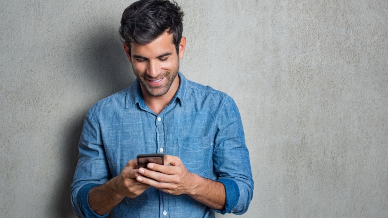 Man smiling as he uses his phone safely, Why I Finally Switched to a Password Manager