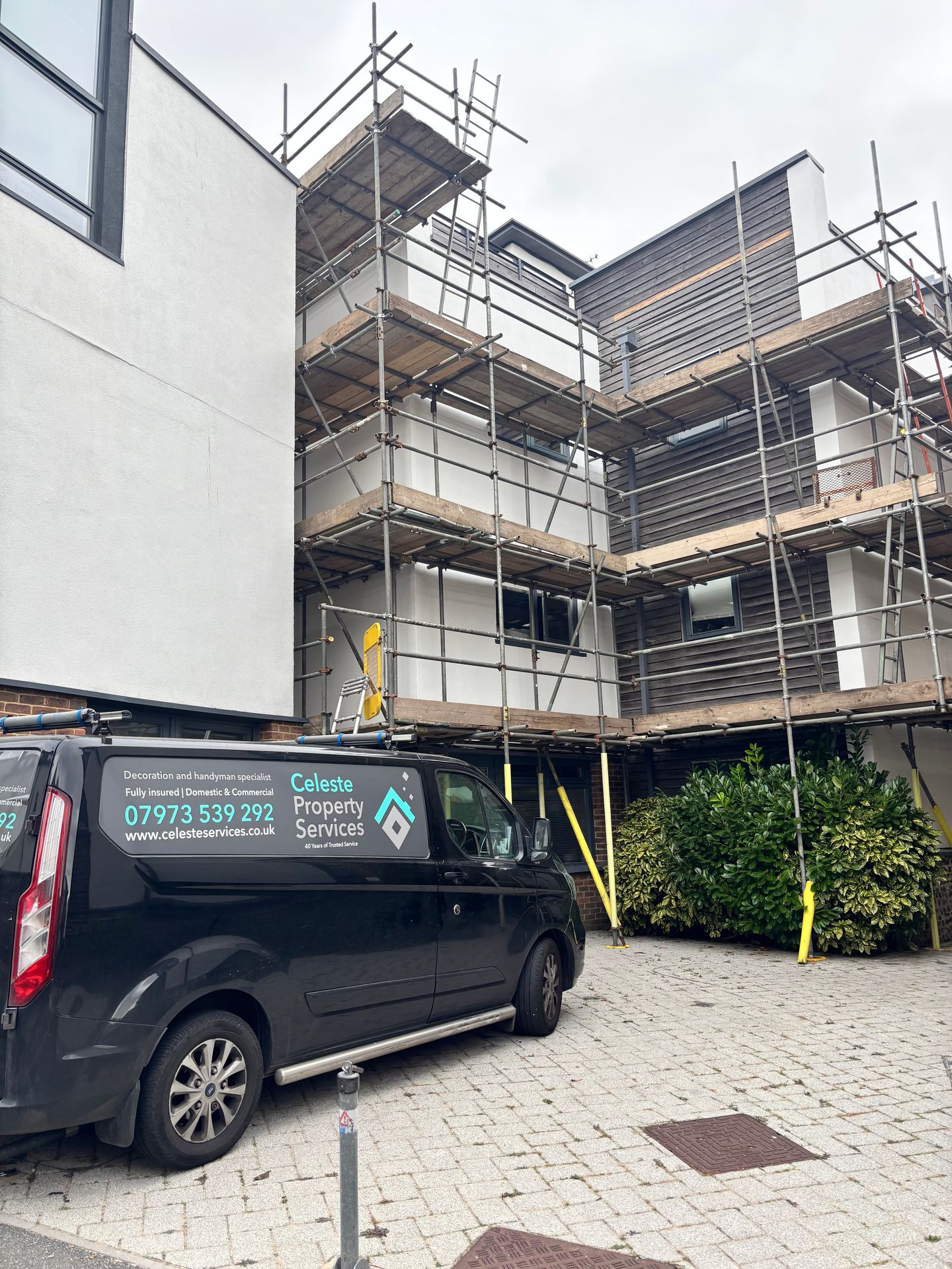Scaffolding in place around a residential building, preparing exterior render for repainting with Dulux Weathershield.
