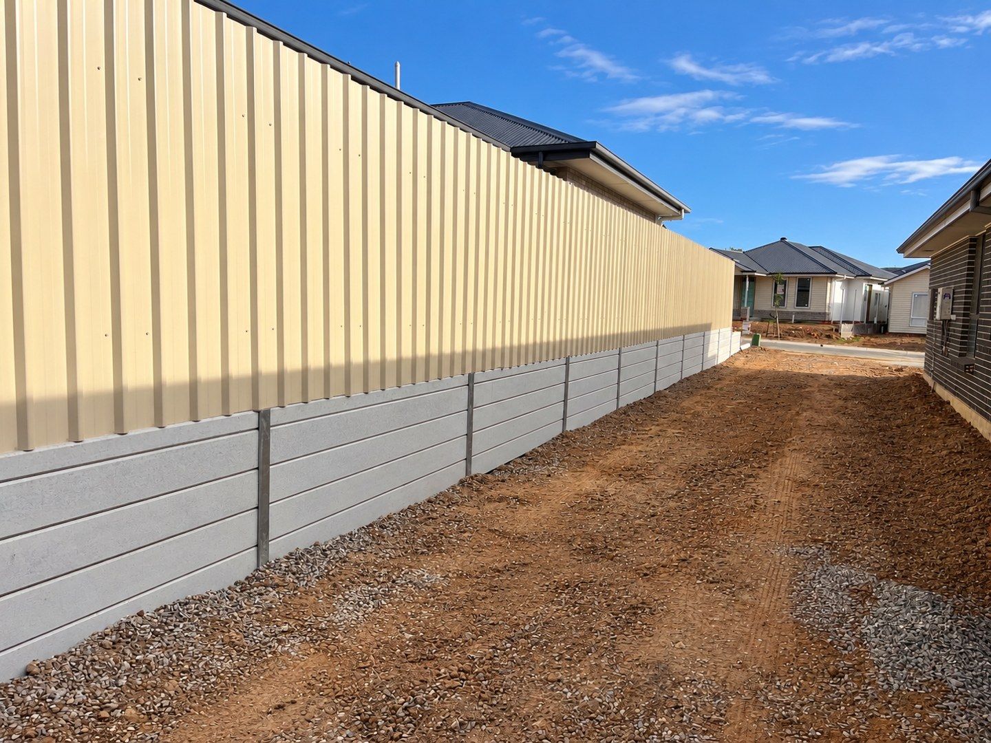 Concrete sleeper wall beneath boundary fencing