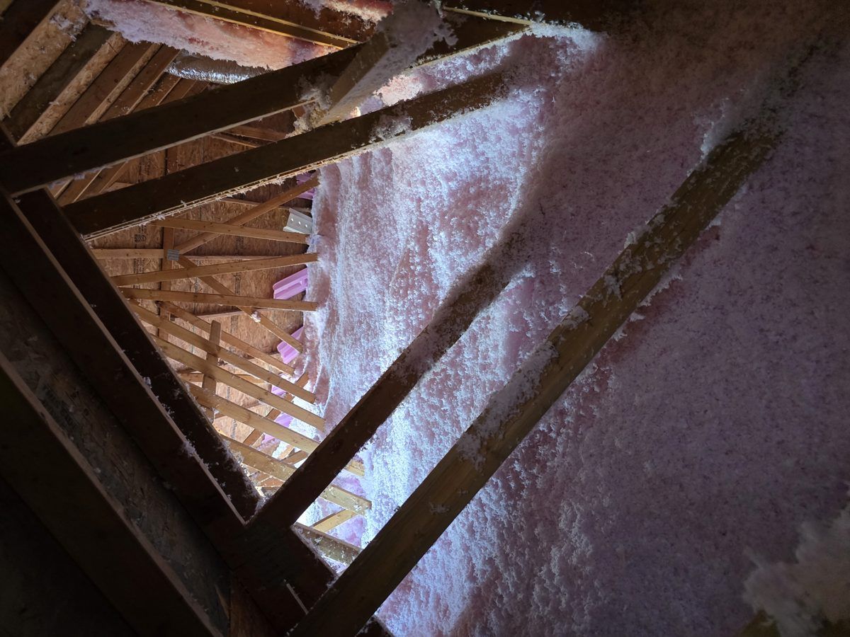 New pink AttiCat insulation blown up to the roof slope