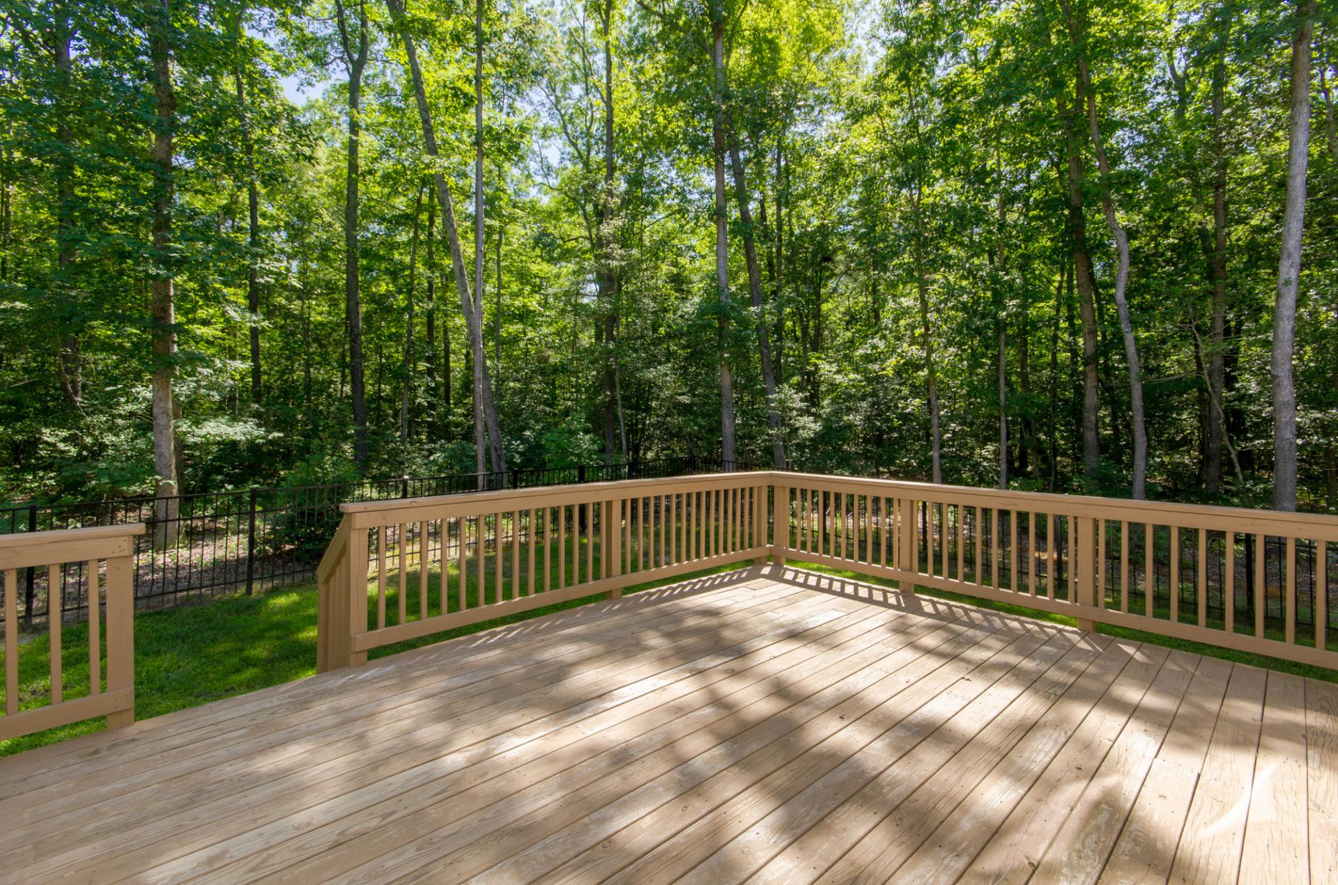 Pressure treated lumber deck with railings