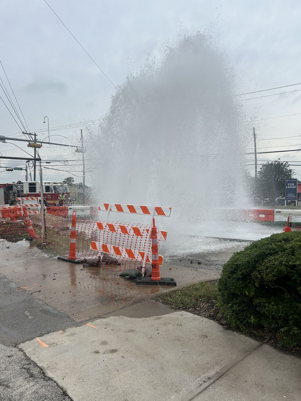 Water main break flooding a roadway after a utility strike Water main break flooding a roadway after a utility strike