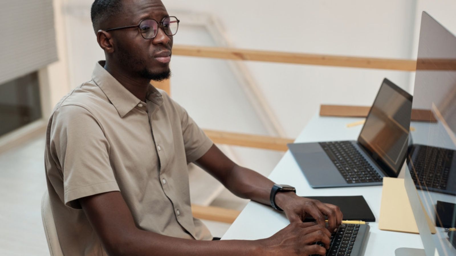 Man working at a desk with online safety in mind, The Five Security Fixes I'd Make First in Your Position