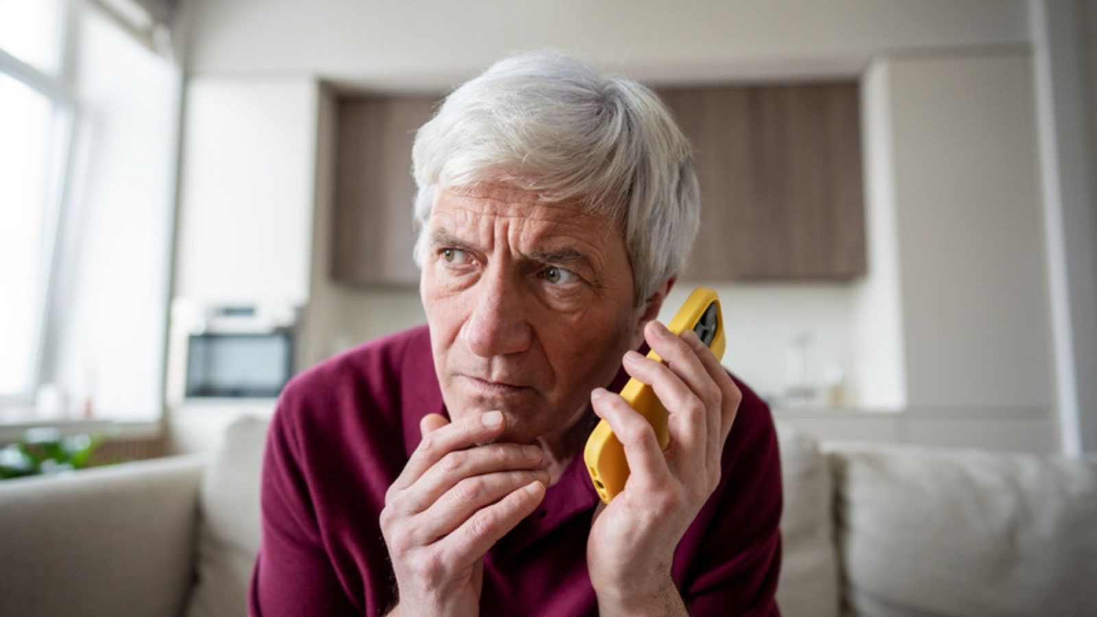 Worried older man on a suspicious phone call, The Simple Checks I Use to Stop AI Scams