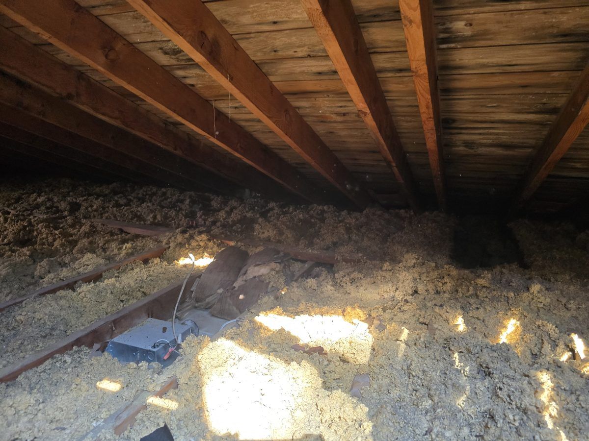 Thin old insulation in an attic before MichConn