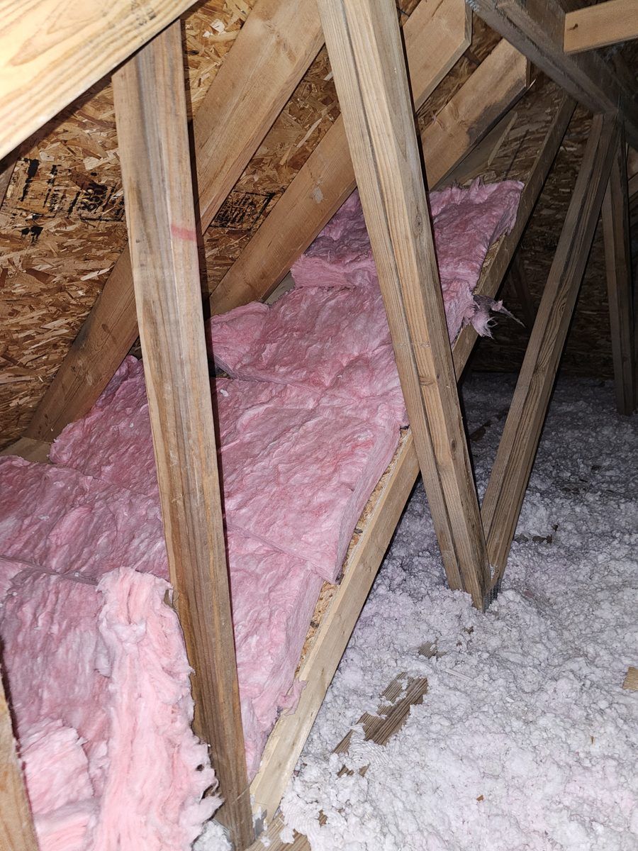 Pink fiberglass batts sealing the roof slope in an attic by MichConn