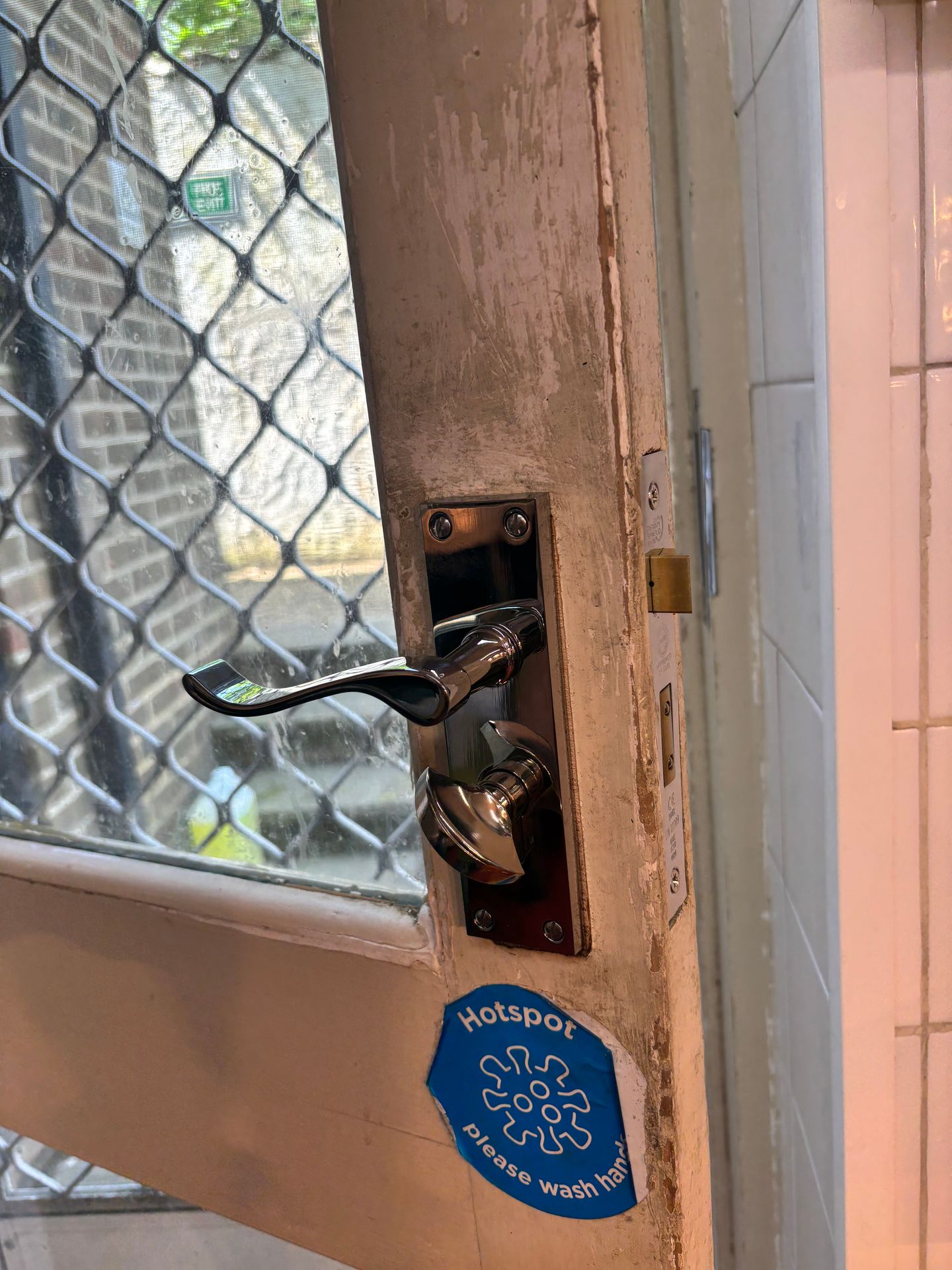 Finished lock replacement on rear door showing clean, secure fitting.