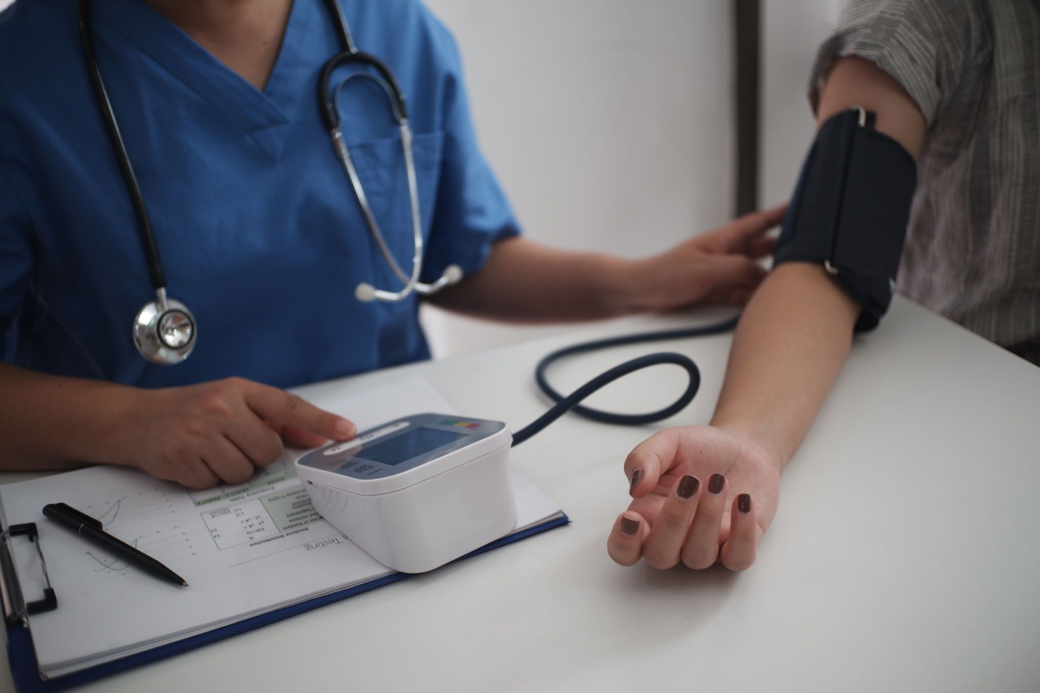 Nurse measuring blood pressure of a patient Nurse measuring blood pressure of a patient
