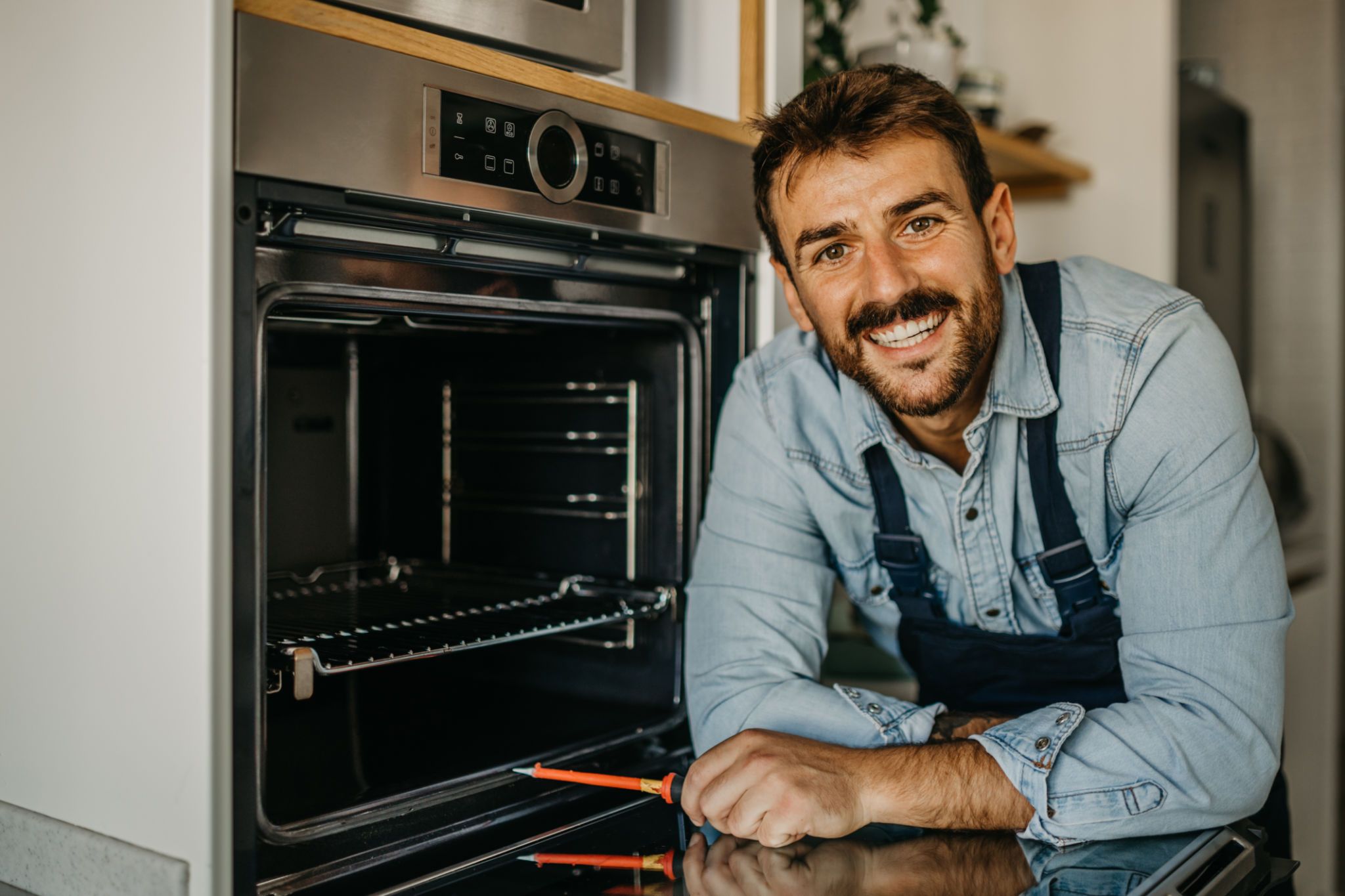 technician fixing appliance