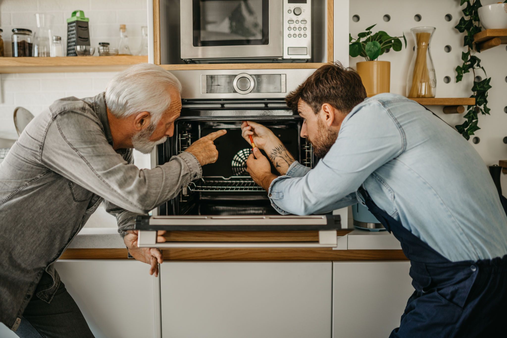 man repairing appliance