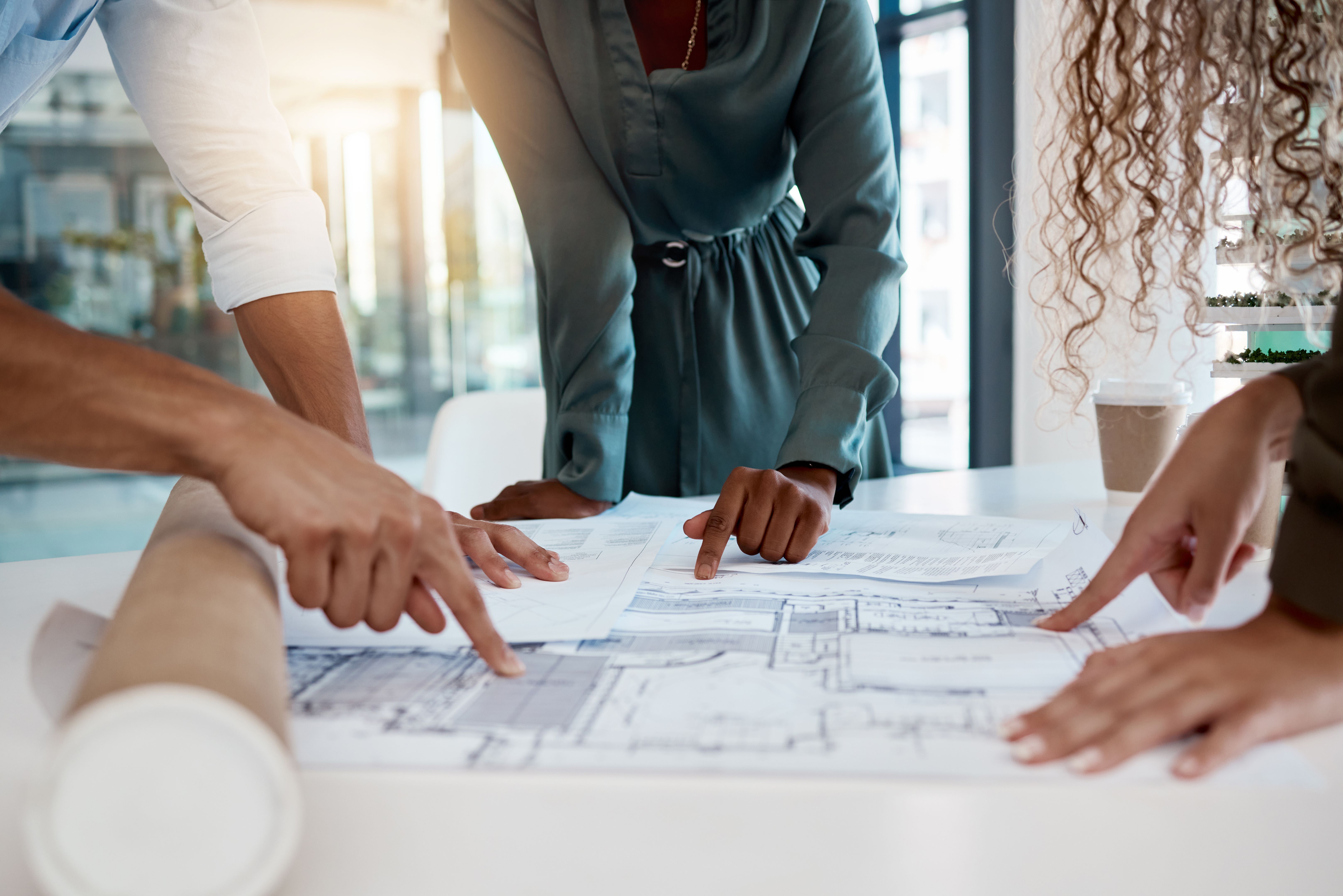 Architecture, engineering team and hands with blueprint for planning, building strategy and meeting. Construction site, property development and contractors with illustration, design and floor plan