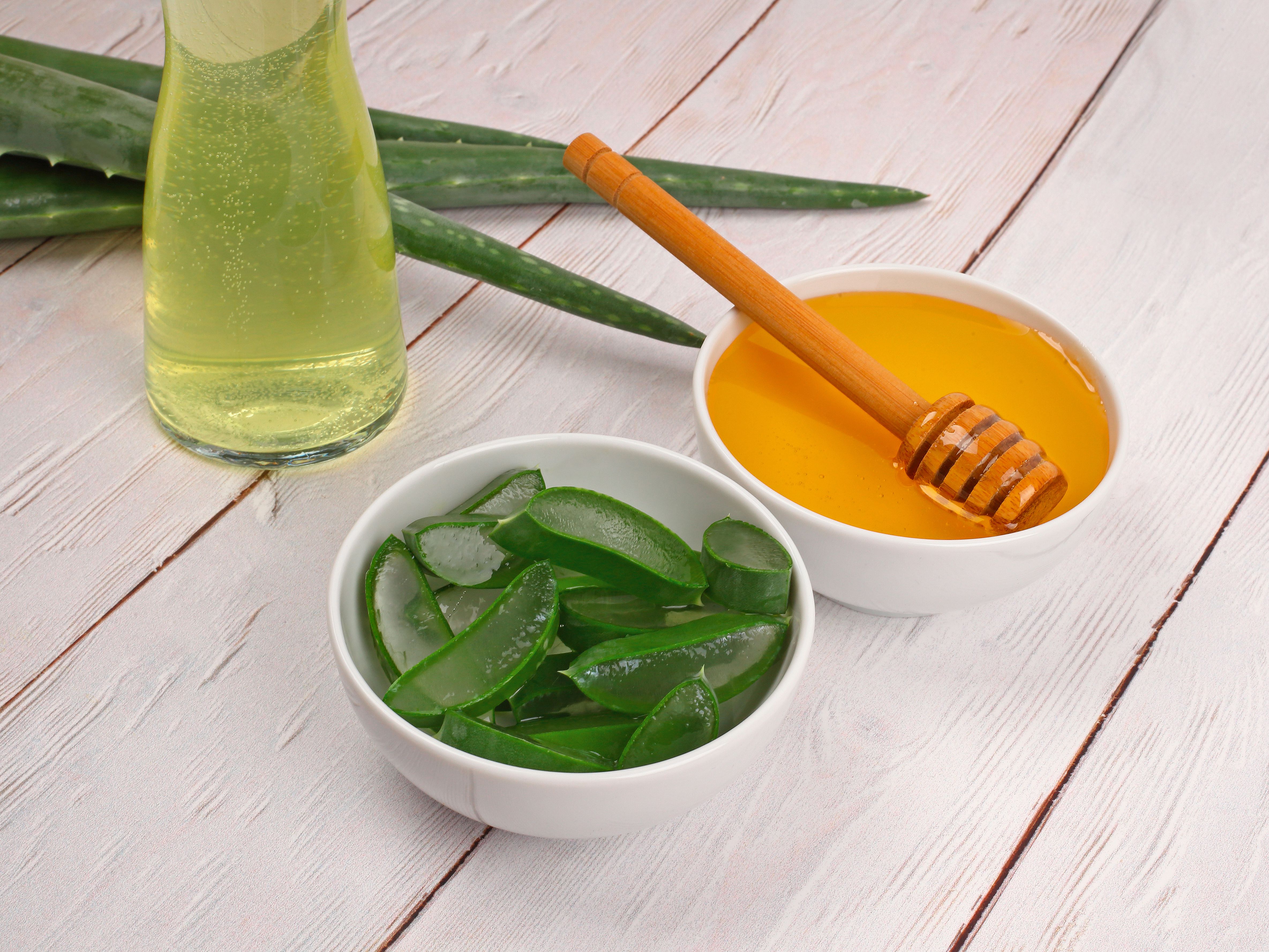 Aloe Vera and honey closeup on light wooden background Aloe Vera and honey closeup on light wooden background