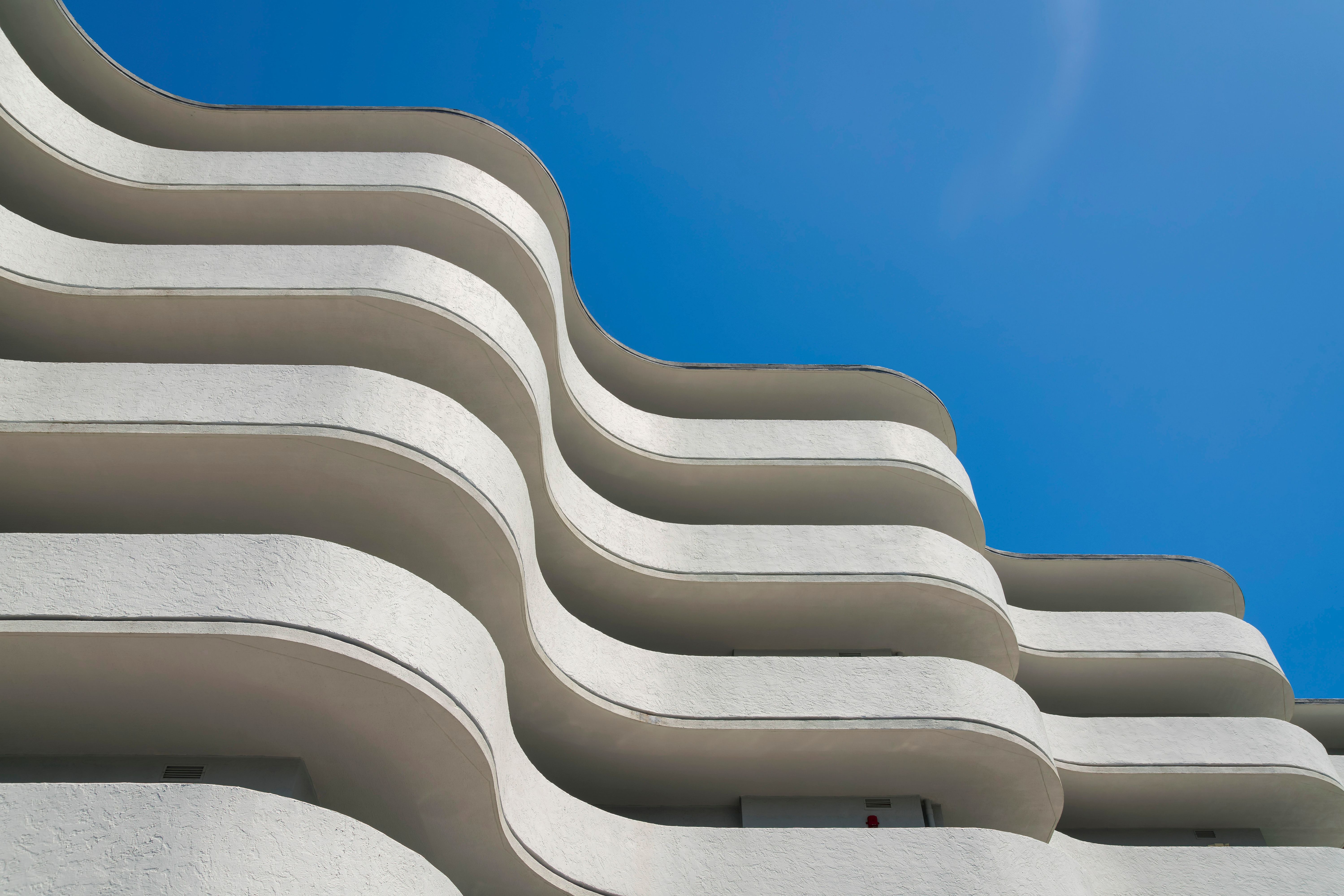 Low angle view of a building with curved walls under the clear blue sky at Miami, Florida