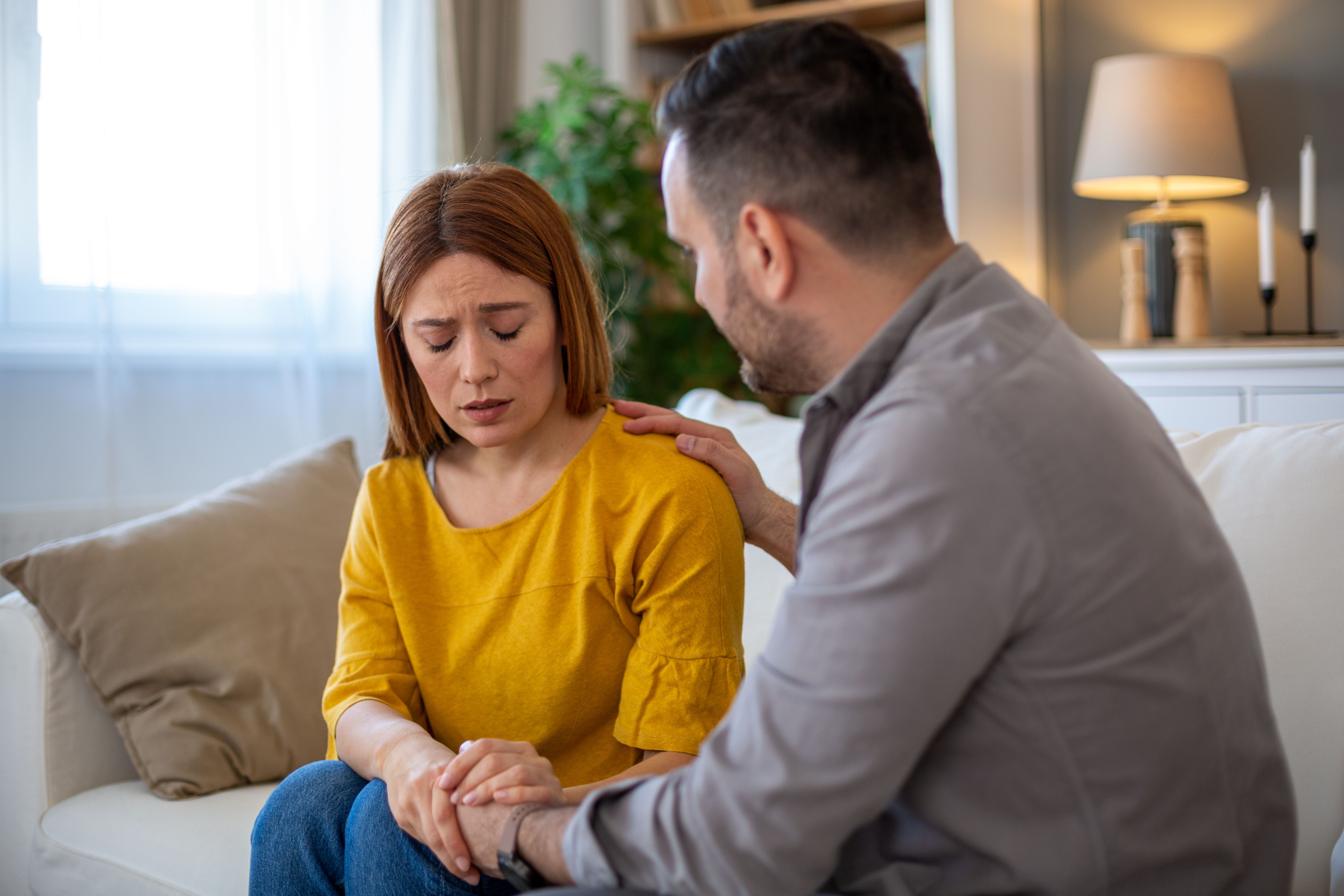 Man comforting his sad wife