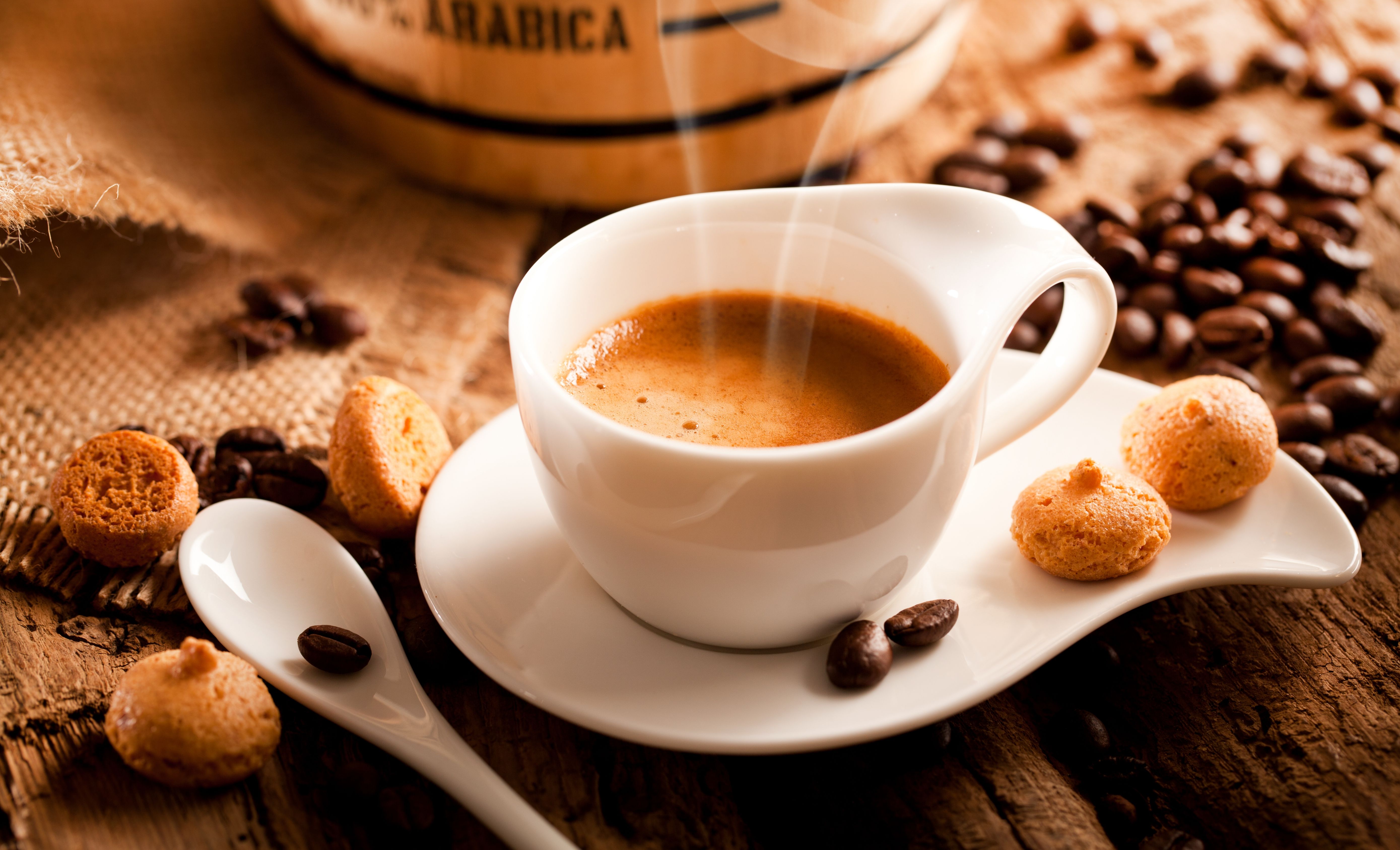 A cup of espresso coffee on a dark wooden background. Top view. Free space for text. A cup of espresso coffee on a dark wooden background. Top view. Free space for text.