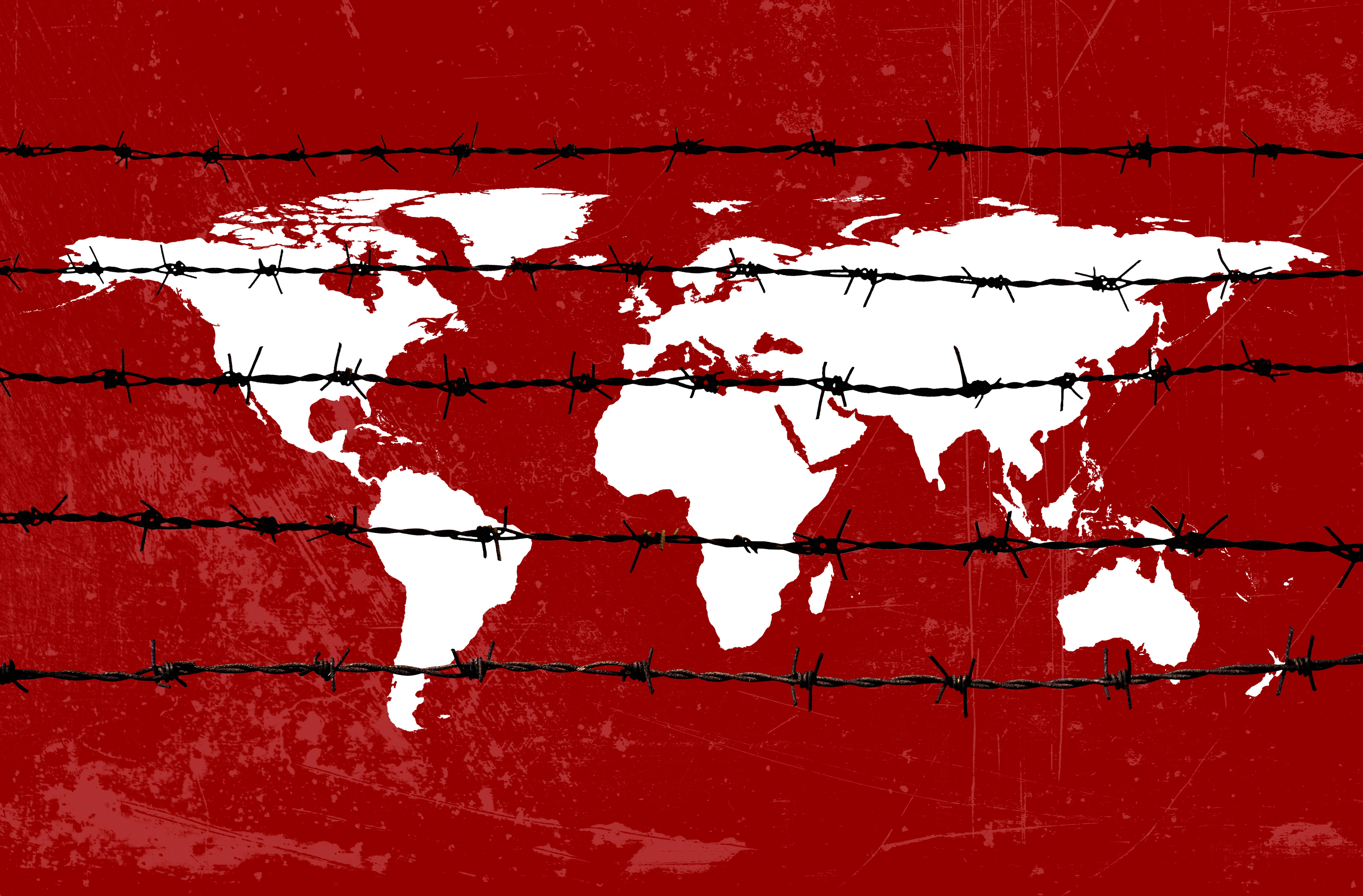Global crisis concept of damaged world map with barbed wire