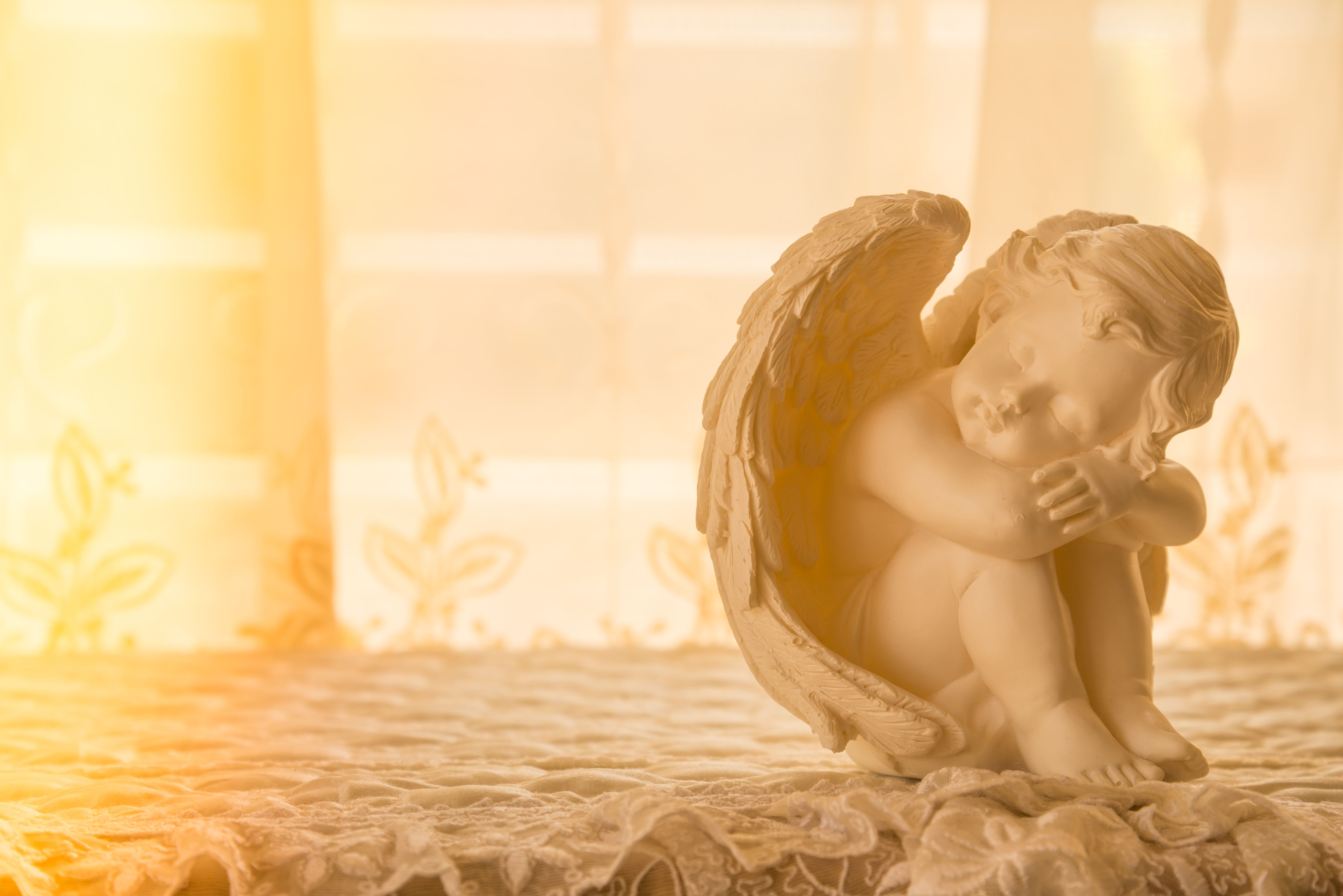 Cute cupid statue with beautiful light leak.